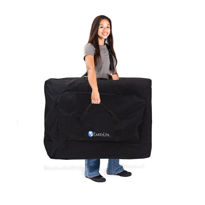 Massage Therapist carrying the Earthlite Avalon XD Tilt Top in its carrying case