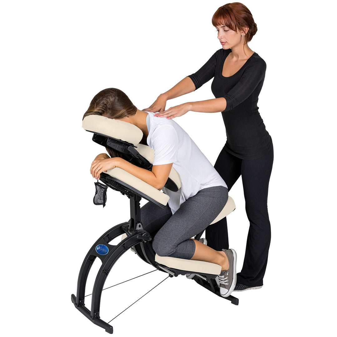 Massage therapist providing care for a patient using Earthlite Avila II portable massage chair in Light Creme