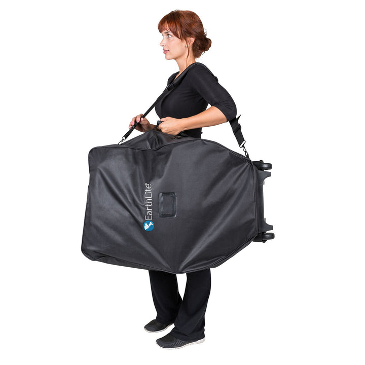 Massage therapist carrying Earthlite Avila II portable massage chair in carrying case.
