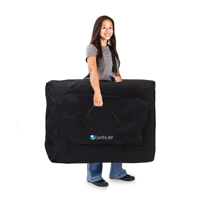 Massage therapist carrying the Luna light weight portable massage table in its carrying case.
